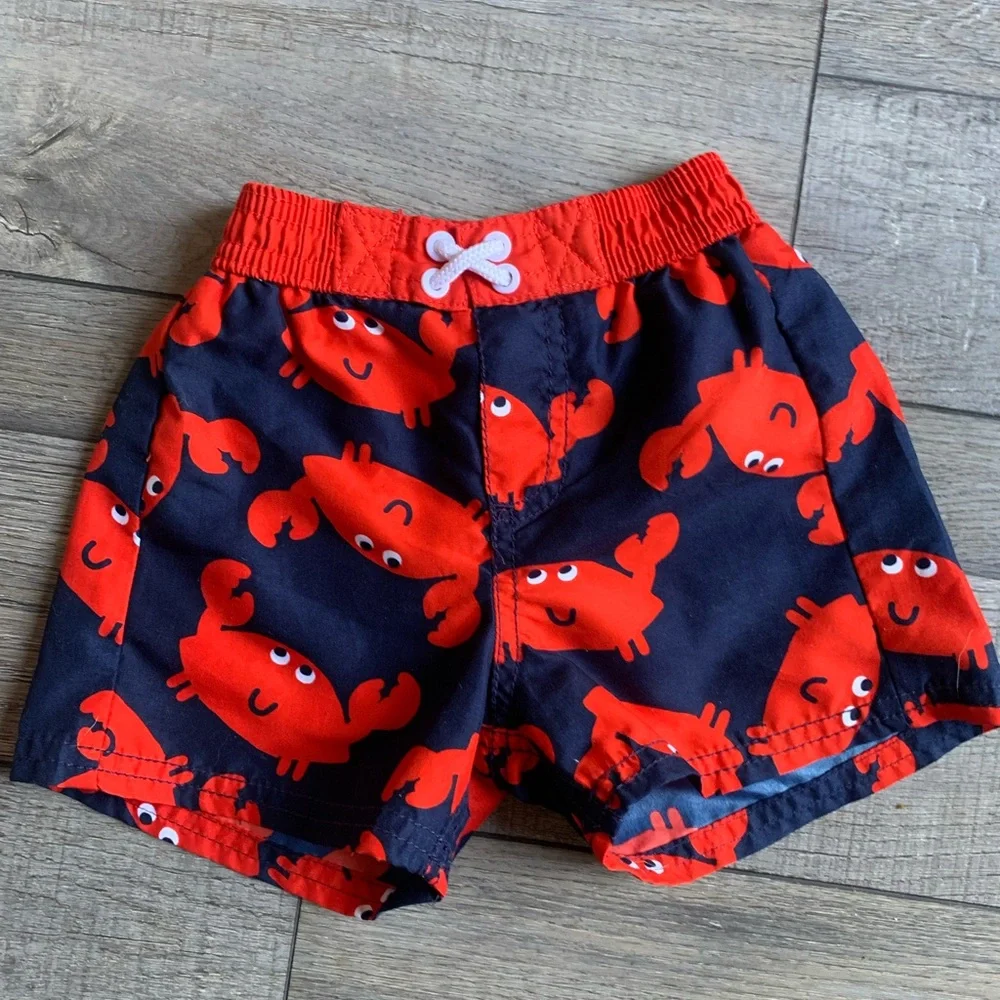 2 Pr. Boys Swim Trunks-Carter’s Crab Swim Trunks and Cat & Jack Pineappl…